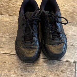 New Balance womens Black Leather Athletic Sneakers.